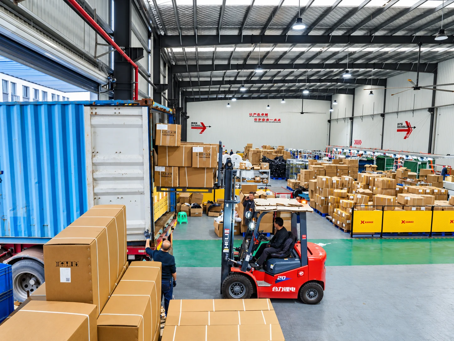 KAMAX workers packing motorcycle components into cartons for CKD shipment.