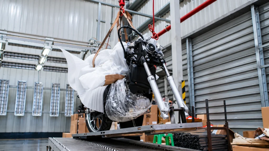 KAMAX workers preparing motorcycles for SKD packaging at our factory.